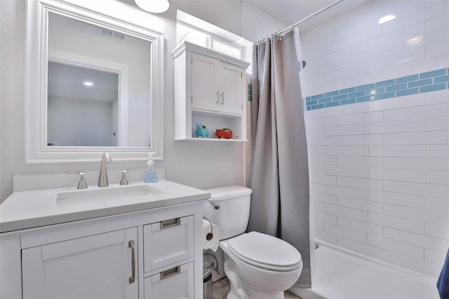 bathroom with visible vents, a stall shower, toilet, and vanity