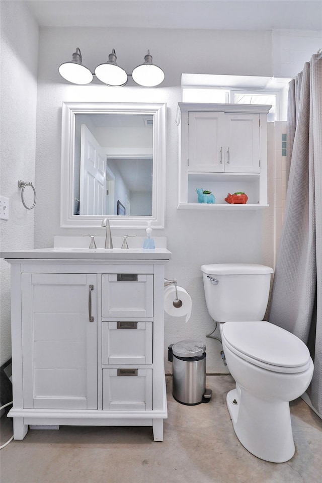 bathroom featuring vanity and toilet