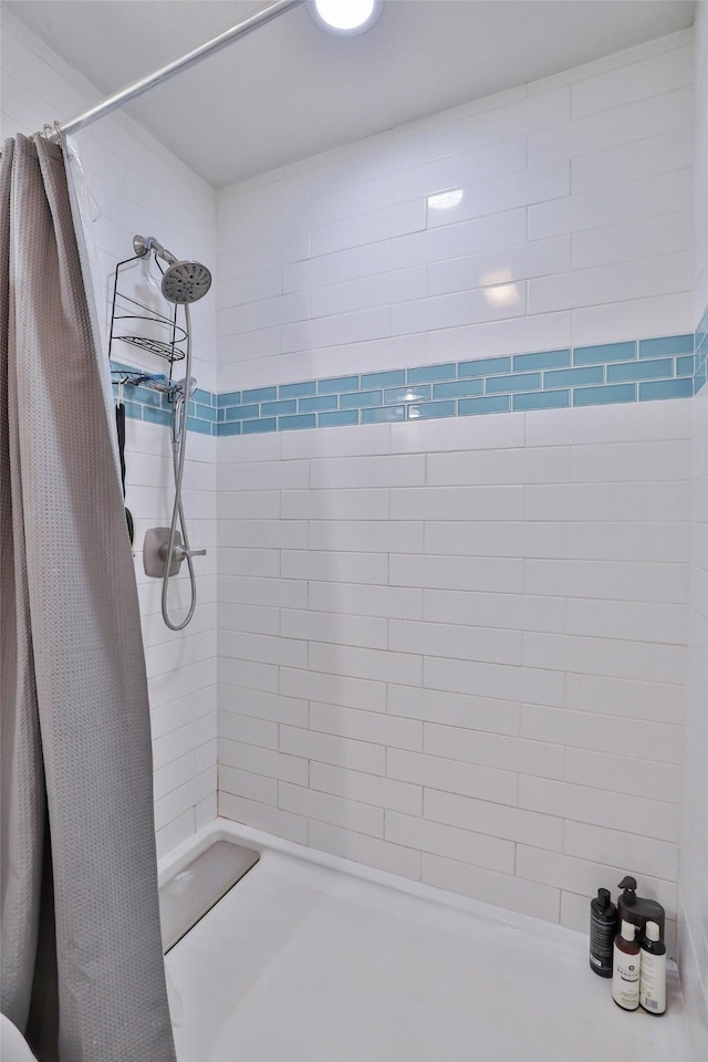 full bath featuring a tile shower