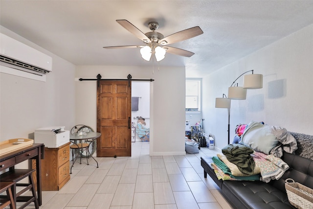 interior space with light tile patterned floors, an AC wall unit, a barn door, and ceiling fan