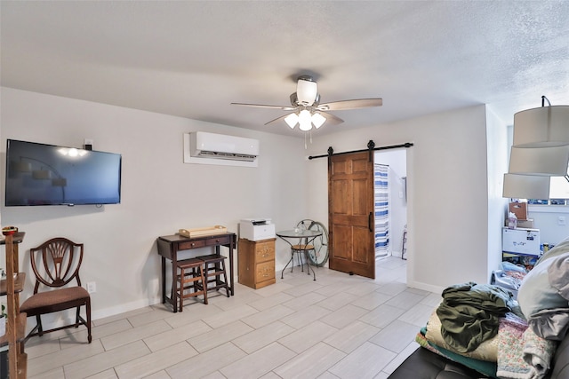 tiled living room with an AC wall unit, a textured ceiling, ceiling fan, and a barn door