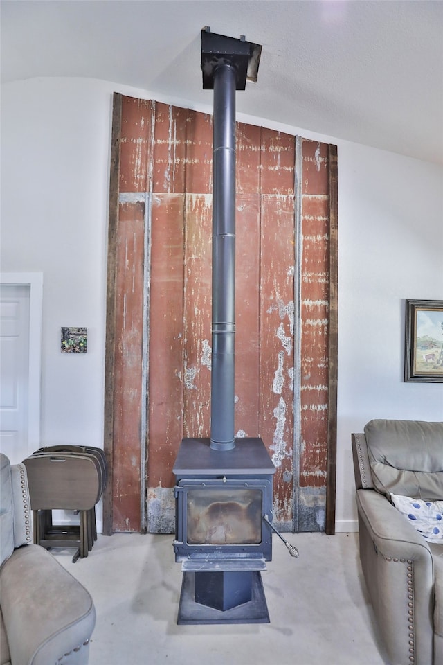 interior details with a wood stove and concrete flooring