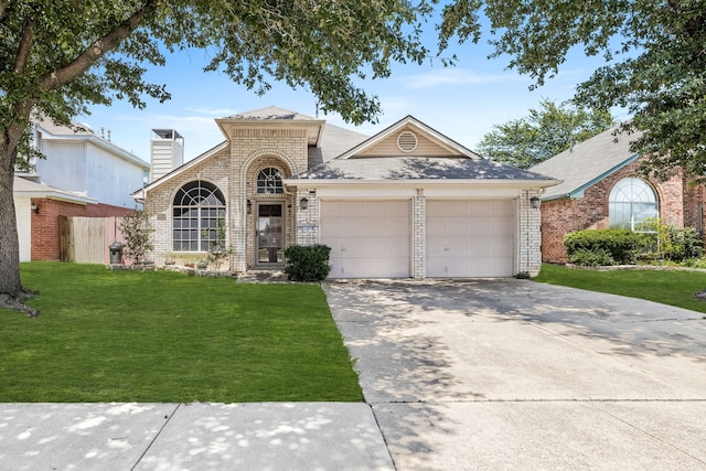 view of front of property with a garage and a front lawn