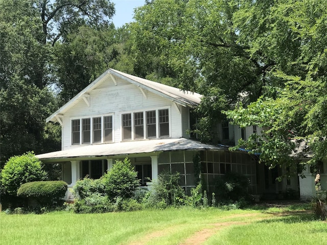 rear view of house with a lawn