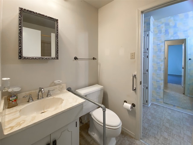 bathroom with vanity, tile patterned flooring, and toilet