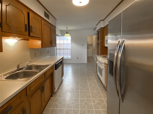 kitchen featuring crown molding, white appliances, light tile patterned floors, decorative light fixtures, and sink