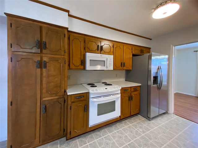 kitchen featuring light wood-type flooring and white appliances