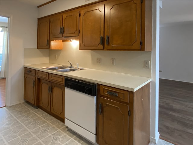 kitchen featuring sink, dishwasher, and light hardwood / wood-style flooring