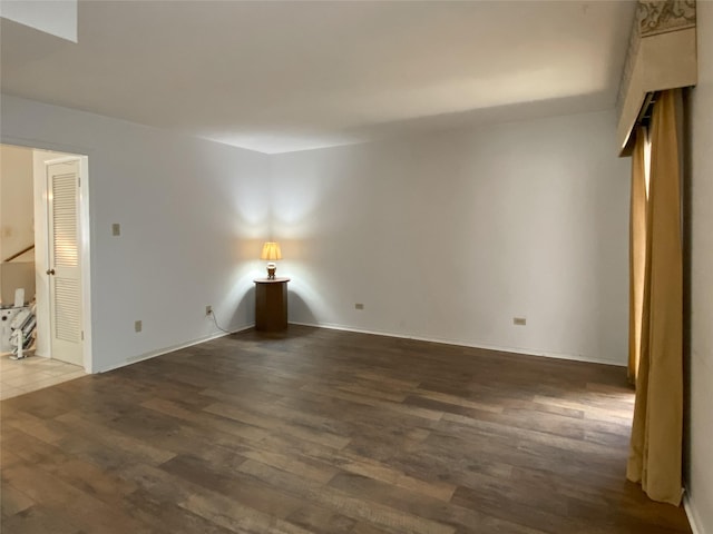 spare room featuring wood finished floors