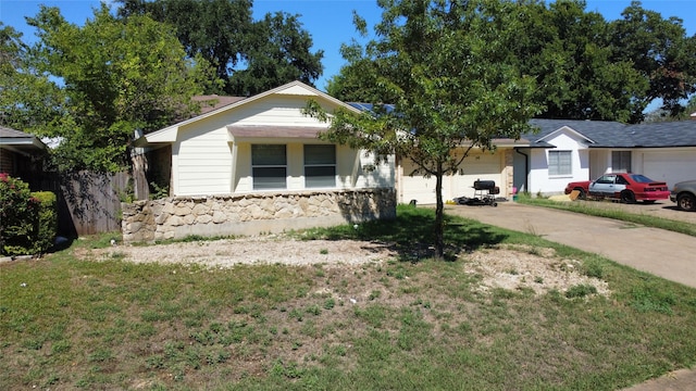 ranch-style house with a garage and a front yard