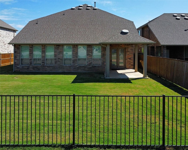 back of property featuring a yard and a patio area