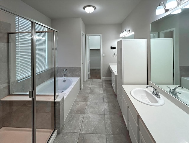 bathroom featuring plus walk in shower, tile patterned flooring, and vanity