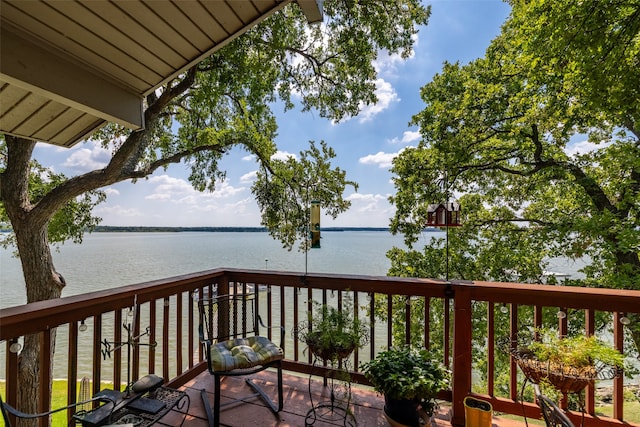 wooden deck featuring a water view