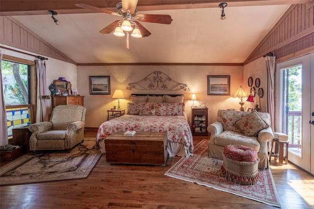 bedroom with lofted ceiling, multiple windows, and wood-type flooring