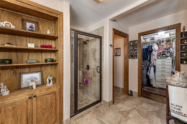 bathroom featuring a shower with shower door