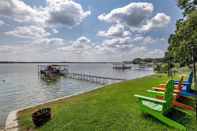 dock area featuring a water view and a yard