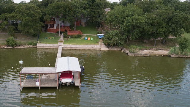 view of dock featuring a lawn and a water view