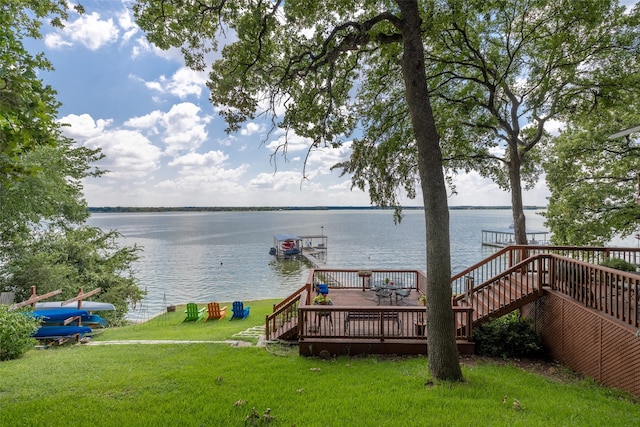 dock area with a lawn and a deck with water view