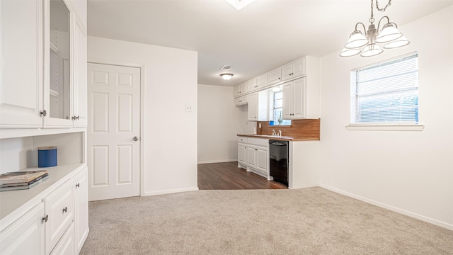 kitchen with dark colored carpet, decorative light fixtures, black dishwasher, and white cabinets