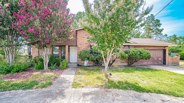 view of front of property with a garage and a front yard