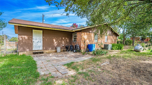 back of house featuring a patio area and central air condition unit