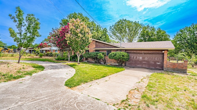 view of front of home with a garage and a front yard