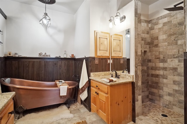 bathroom with tile patterned flooring, independent shower and bath, and vanity