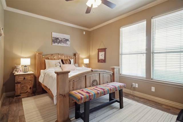 bedroom with hardwood / wood-style flooring, crown molding, and ceiling fan