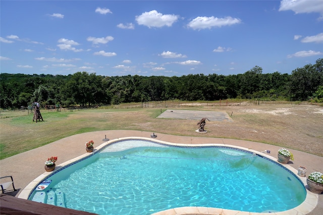 view of pool with a yard