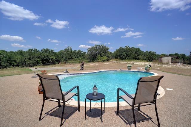 view of swimming pool with a patio