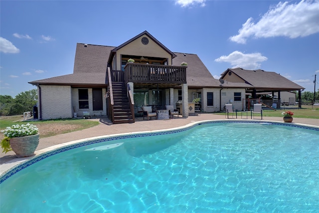 view of swimming pool with a deck and a patio