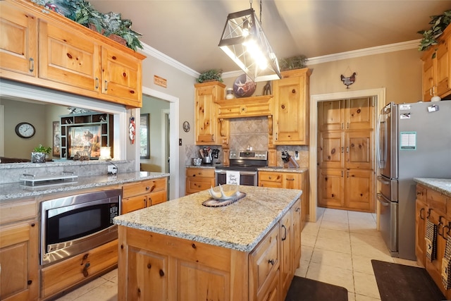 kitchen with tasteful backsplash, light stone counters, a kitchen island, appliances with stainless steel finishes, and light tile patterned floors