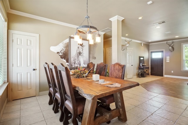 tiled dining space with decorative columns and ornamental molding