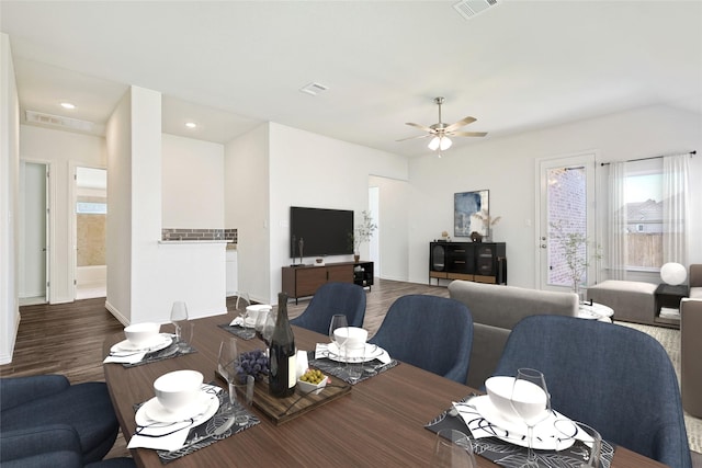 dining space with ceiling fan and dark wood-type flooring