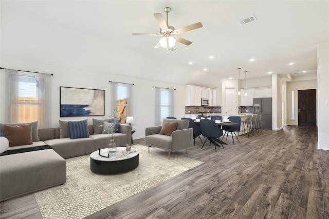 living room with hardwood / wood-style flooring, ceiling fan, and lofted ceiling