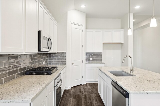 kitchen featuring white cabinetry, hanging light fixtures, sink, stainless steel appliances, and light stone counters