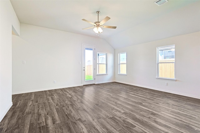 spare room with a wealth of natural light, dark wood-type flooring, and lofted ceiling