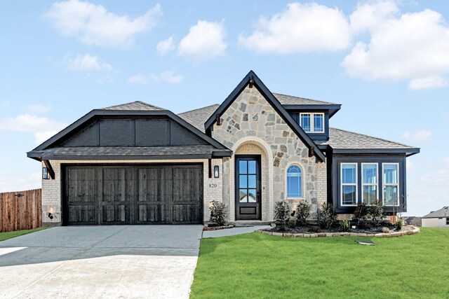 english style home with a garage and a front yard