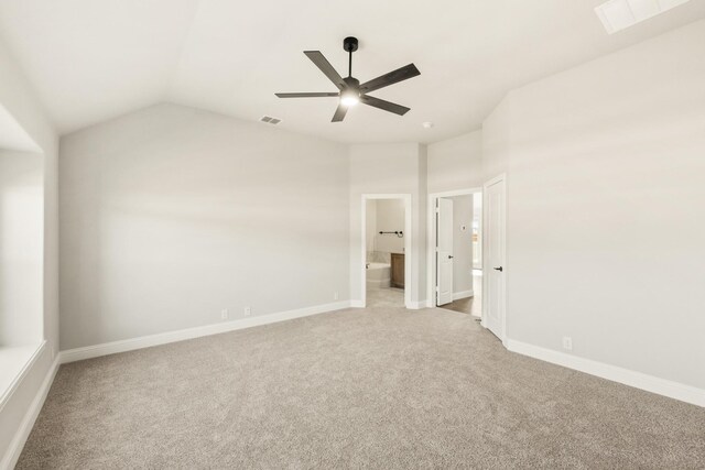 carpeted bedroom with connected bathroom, vaulted ceiling, and ceiling fan