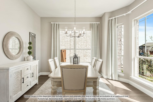 dining space with dark hardwood / wood-style floors and an inviting chandelier