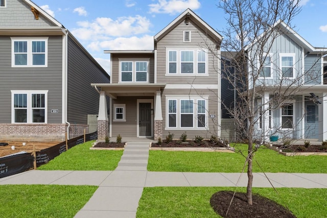 craftsman inspired home with a front lawn