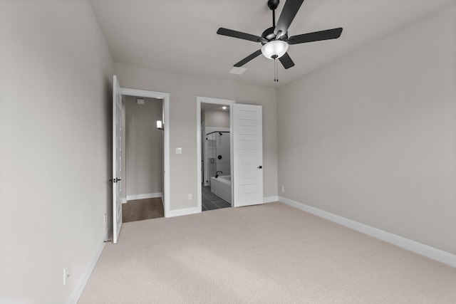 unfurnished bedroom with ensuite bath, carpet floors, and ceiling fan