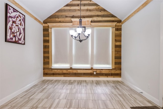 unfurnished dining area with an inviting chandelier, vaulted ceiling, and ornamental molding