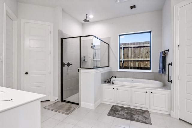 bathroom featuring plus walk in shower and tile patterned flooring