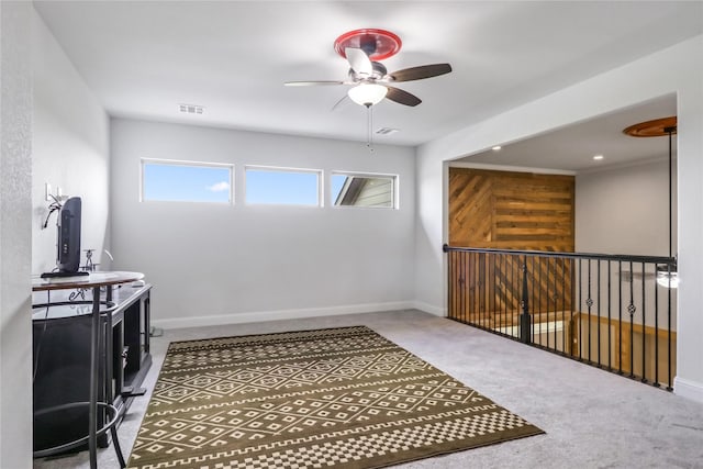 interior space featuring washer and clothes dryer, ceiling fan, and carpet floors