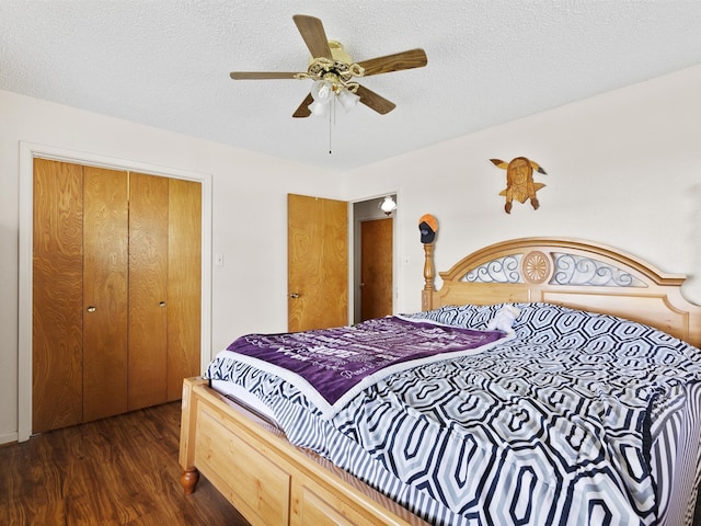 bedroom with dark hardwood / wood-style floors, a textured ceiling, a closet, and ceiling fan