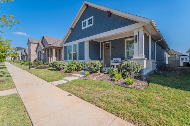 view of front of home with covered porch and a front yard