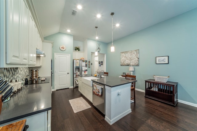 kitchen with vaulted ceiling, a center island with sink, dark hardwood / wood-style floors, and stainless steel appliances