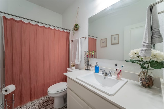 bathroom with tile patterned floors, vanity, and toilet