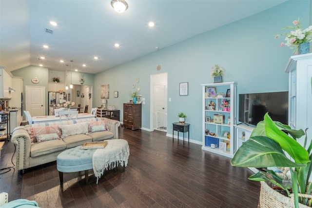 living room featuring dark hardwood / wood-style flooring and vaulted ceiling